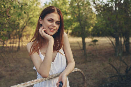 woman in white dress in field trees nature strollの写真素材