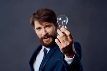 man in a suit holding a lamp idea success innovation