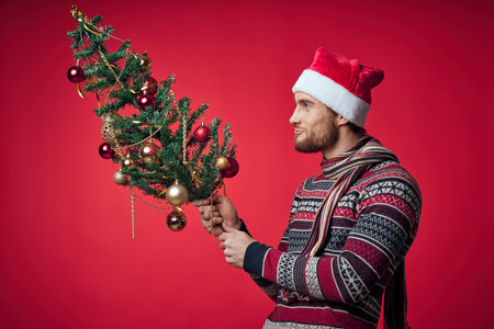 man with christmas tree in hands toys decoration holiday new year