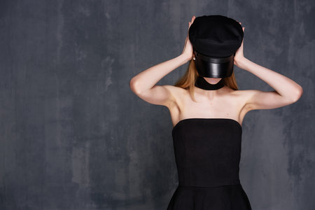 pretty woman in black dress cosmetics luxury home dark backgroundの写真素材