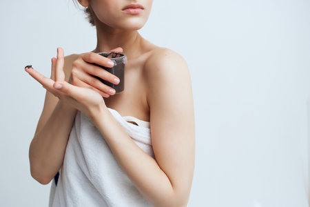 pretty brunette naked shoulders skin care dermatology creamの写真素材