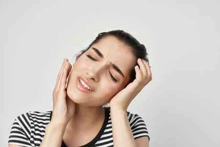 woman in striped t-shirt teeth pain emotions dentistryの写真素材
