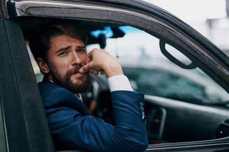 a man in a suit walks in a car travel official transport