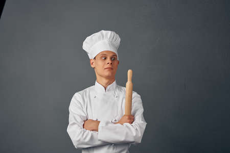 man in chefs uniform frying pan in hands cooking food isolated backgroundの写真素材