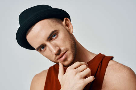 handsome man wearing hat red t shirt fashion posing studioの写真素材