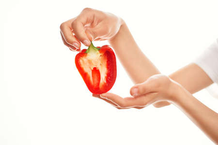 woman holding red pepper in her hands cooking vegetables kitchen ingredient