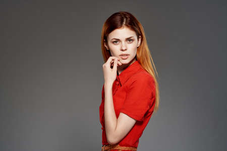 red-haired woman in red dress posing attractive look isolated background