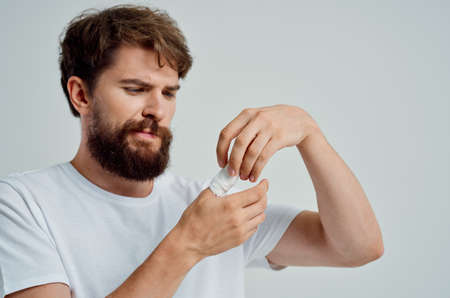 sick man bandaged hand injury to fingers light background