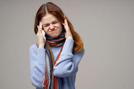 red-haired woman neck scarf cold handkerchief light background