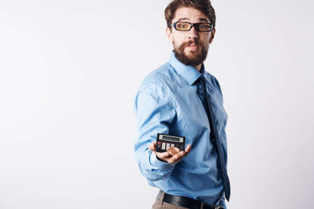 a man in a blue shirt with a calculator in his hands finance Professionalの写真素材