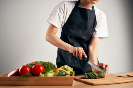 housewife in the kitchen cuts vegetables for salad healthy foodの写真素材