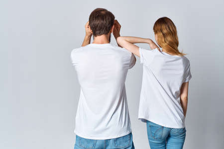 man and woman hugging in white t-shirts mockup back viewの写真素材