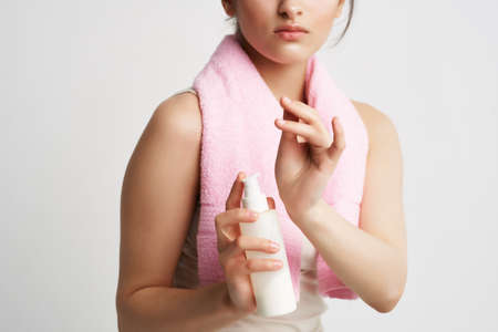 woman with pink towel on her shoulders autumn skin care dermatologyの写真素材
