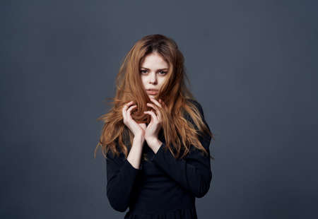 woman with fashionable hairstyle in black dress posing fashion isolated background