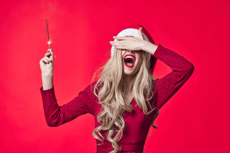 pretty woman in santa hat holiday christmas emotion sparklers