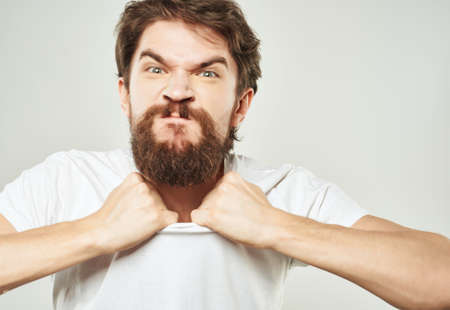Man in a white t-shirt expressive look discontent Studioの写真素材