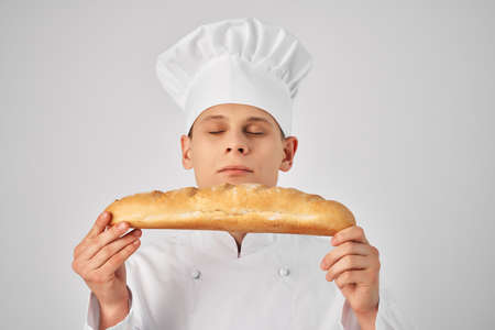 male chef with a baguette in his hands fresh product professional work
