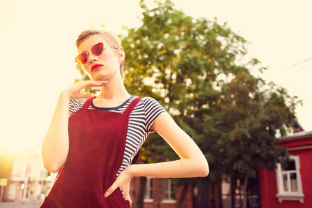 cheerful woman in sunglasses outdoors summer walk fashionの写真素材
