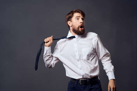 businessmen holding a tie executive office dark backgroundの写真素材