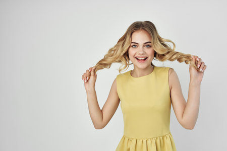 woman in a yellow dress fun cropped view fashionの写真素材