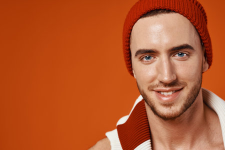 handsome man caps striped sweater studio posing fashion red backgroundの写真素材