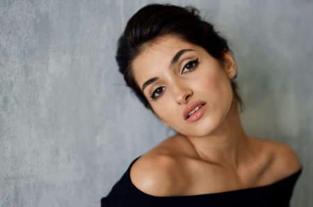 Woman in black dress posing fashion decoration light backgroundの写真素材