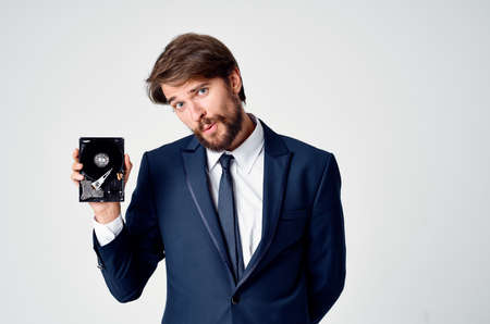 emotional business man with hard drive on computer technologyの写真素材