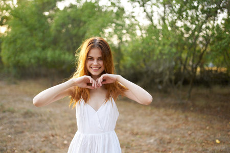 pretty cheerful woman in nature joy freedom sunの写真素材