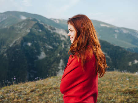 woman in a red plaid in the mountains outdoors fresh air cool