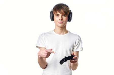 guy in white t-shirt with headphones playing video games gamer
