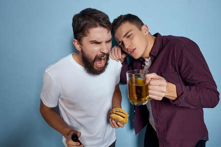 two friends drink alcohol beer entertainment lifestyle communicationの写真素材