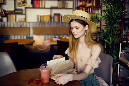 pretty woman sitting at the table library rest reading