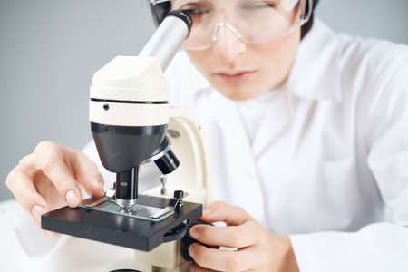 woman laboratory assistant microscope science professional analysis biotechnology