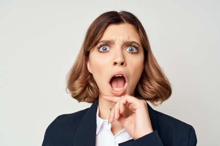 Businesswoman in costume success light background emotions