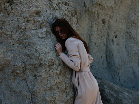 pretty woman posing near rocks in the sand model Travelの写真素材