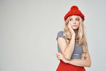blonde in a striped T-shirt Red Hat light background Lifestyleの写真素材