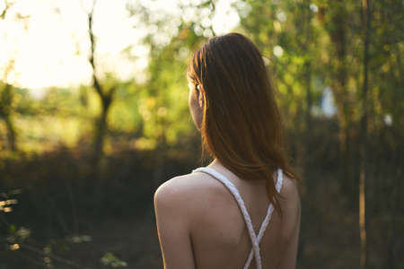 Woman in white dress nature forest trees summer walkの写真素材