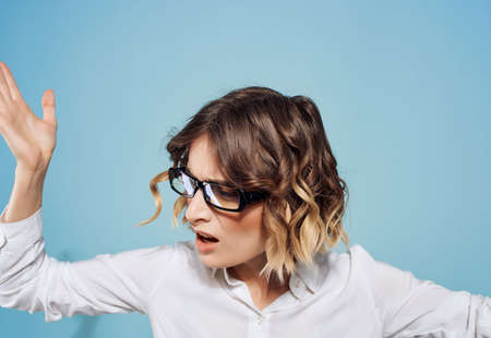 Business woman in white shirt and glasses working office blue backgroundの写真素材