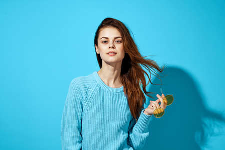pretty woman in a blue sweater blue background Lifestyleの写真素材