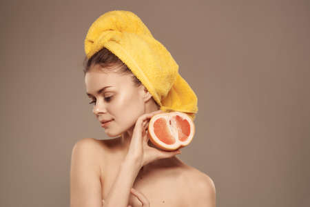 beautiful woman with naked body with fruit vitamins posing close-upの写真素材