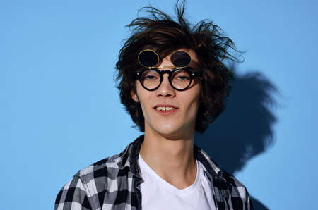 Cheerful guy in plaid shirt tousled hair fashion modern styleの写真素材