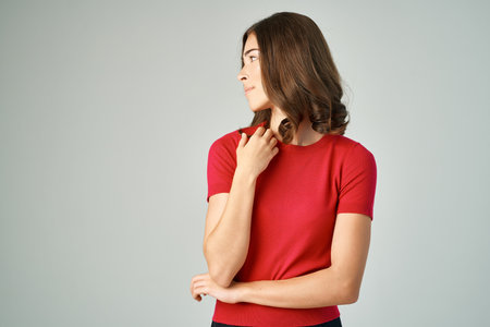 pretty woman surprised look emotions light backgroundの写真素材