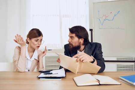 work colleagues office work desk communication emotionsの写真素材