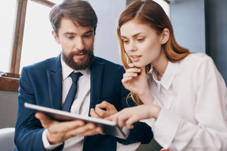 business man and woman communicate with the tablet technology officeの写真素材