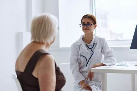 old woman patient examination by a doctor health diagnosticsの写真素材