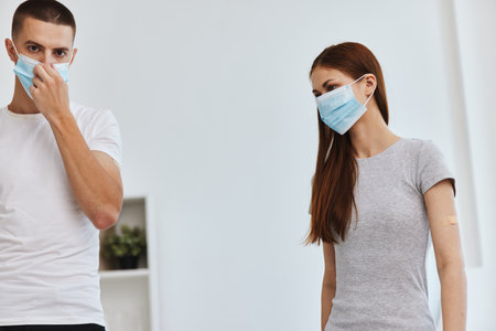 young couple wearing medical masks covid-19 vaccination passportの写真素材