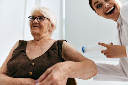 emotional elderly woman big syringe immunity protectionの写真素材