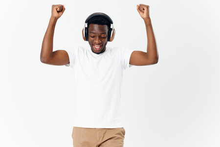 man african appearance headphones listening to music emotions light backgroundの写真素材