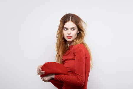pretty woman with a red cap on his head glamor light background