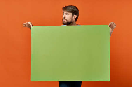 funny man advertising marketing copy space orange backgroundの写真素材